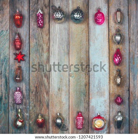 frame of vintage Christmas tree decorations on a wooden retro grunge background, top view