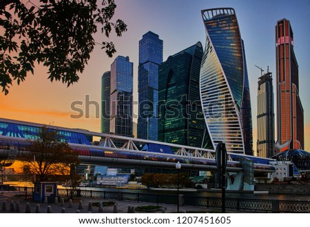 Moscow City. Twilight. bright red sunset. against it blue,green skyscrapers business center Moscow city. In the frame of a fragment of the Moscow river with the reflection of the sunset and towers.