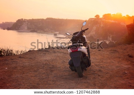 Motorcycle by the sea at dawn