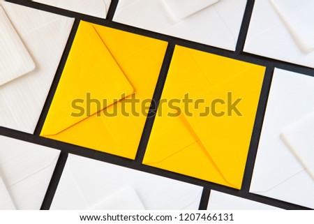 Composition with white and yellow, envelopes on the table. Different colored envelopes on the table.