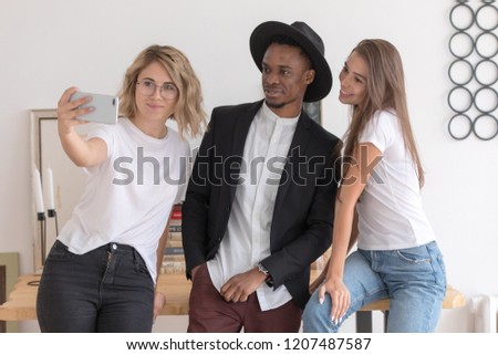 Multiracial group of friends make a selfie.