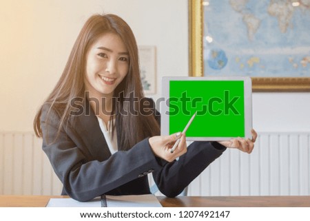 Business Girl working in the office.Businesswoman working on laptop in her workstation. Green screen concept.