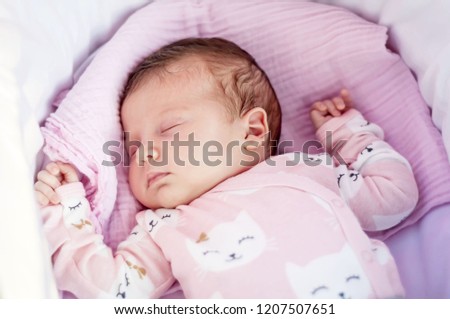 Sweet Caucasian newborn baby sleeping in the cradle or baby carriage. Baby sleep concept stock image.