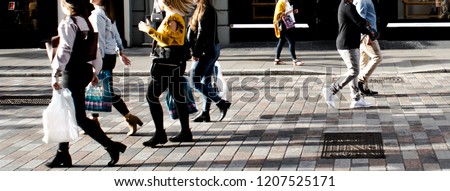 Wide angle view of anonymous shoppers walking on high street Royalty-Free Stock Photo #1207525171