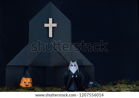 The Halloween background of origami (or Paper folding) that the nun standing in front of black church with jack-o-lantern and spider with messy lawn isolated on black background with space for text.