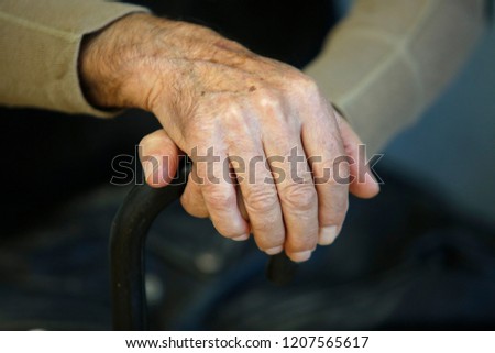 hand of a old man holding a cane