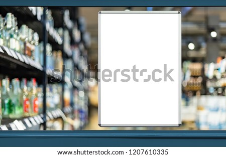 Empty advertising board in liquor store showcase