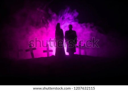 Horror Halloween concept. Scary zombie bride on a night cemetery.