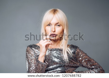 Perfect Blonde girl cut forelock. Close up hairstyle with bangs. Hair care concept. Blonde woman with beautiful hair on gray background Royalty-Free Stock Photo #1207688782