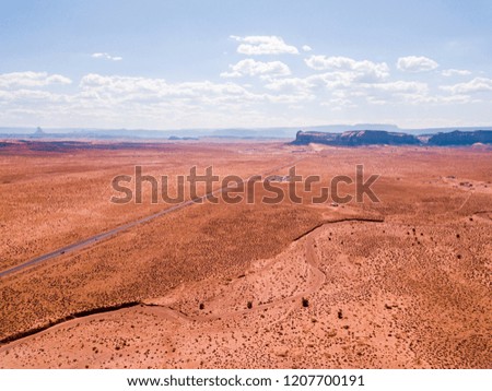 Aerial view of the Monument Valley National park with amazing monuments and endless road