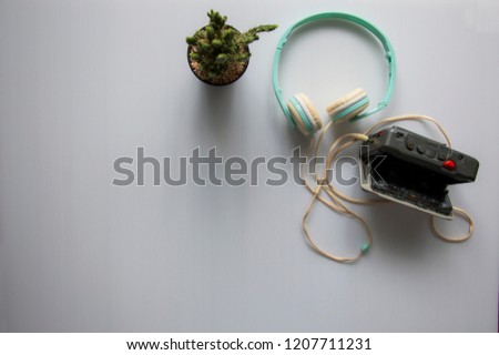 Vintage portable cassette player for listened cassette song on wooden background., cassette tape and headphones isolated on white background.
