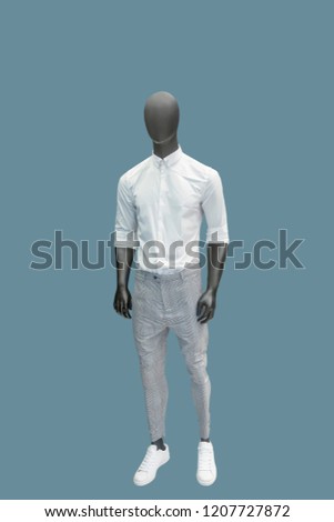Full-length male mannequin dressed in casual clothes, isolated. No brand names or copyright objects.