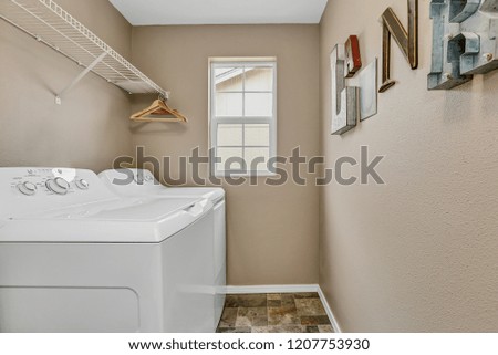 Laundry room interior with washer and dryer .