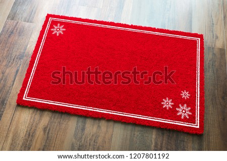 Blank Holiday Red Welcome Mat With Snow Flakes On Wood Floor Background.