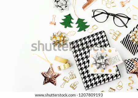 Christmas winter decorations, business stationery and gifts from secret Santa on white background. Office celebration concept. Flat lay, top view
