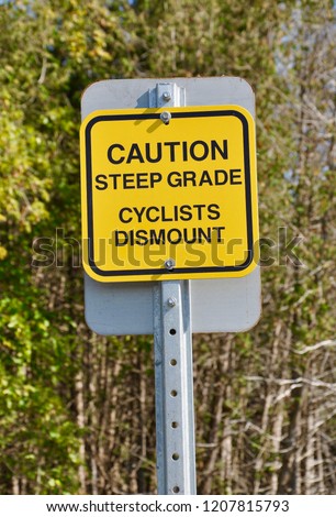 Caution steep grade cyclists dismount signs