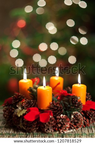 Advent decoration. Four burning candles, ornaments and christmas tree branches. Vintage style toned picture