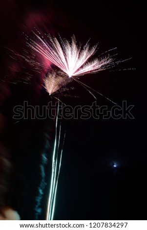 Long exposure of fireworks exploding in the sky at night