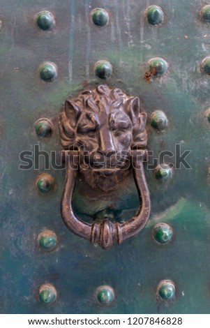 Close Up of an Old Clapper with the Head of Lion on an Old Door