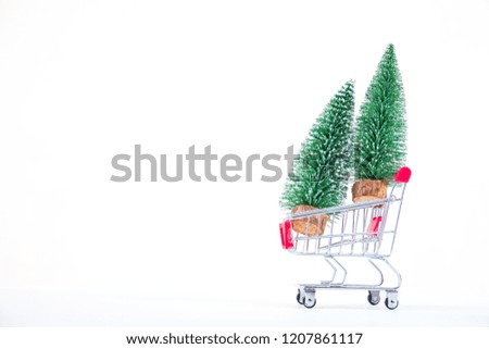 Christmas tree with shopping cart  miniature Christmas decoration isolated on white background. Merry Christmas and happy new year concept. 