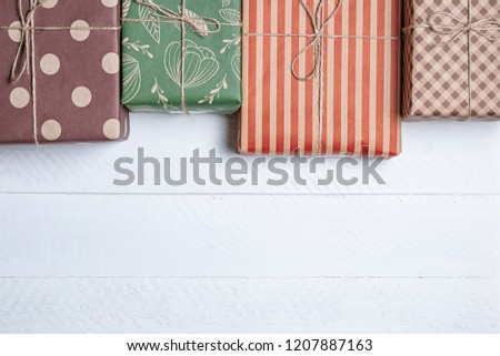 colorful boxes with gifts on a white wooden background with a place for copy space