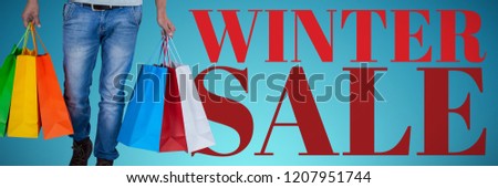 Portrait of young man carrying colorful shopping bag against white background against abstract blue background