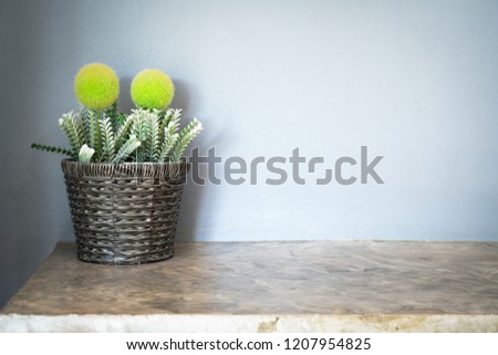 artificial small tree in a luxury flower pot with grey cement wall, copy space