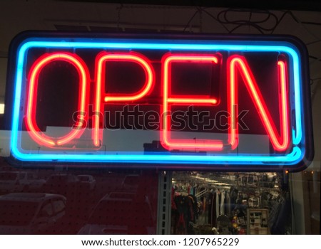 An Orange and Blue Neon Sign that says OPEN