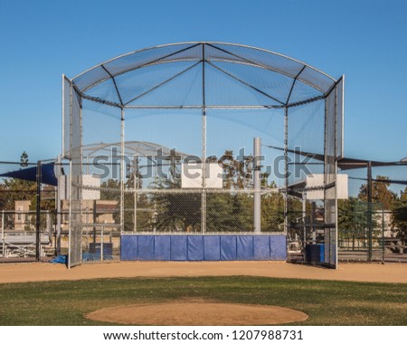 View of batting cage in community park baseball field  Royalty-Free Stock Photo #1207988731