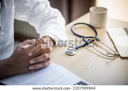 Doctor put his stethoscope while talking with his patient.