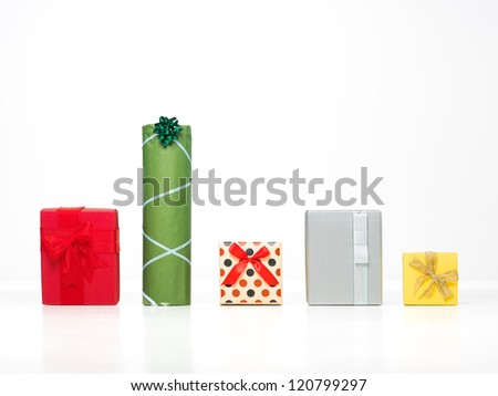 different shaped colorful presents in a row with pretty deorations isolated on white background, cut out
