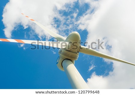 An image of windturbines against blue sky