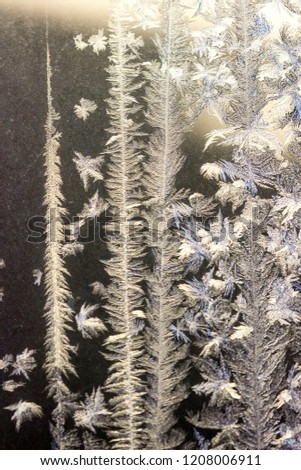 closeup of snowy, frosty patterns on window glass in winter