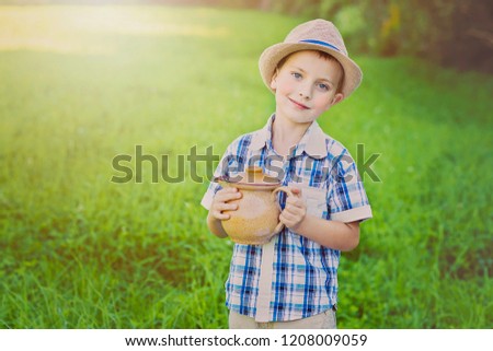 handsome little boy with jug