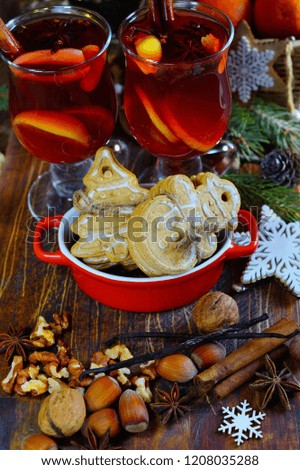 Decorative cookies in the shape of a Christmas tree and snowman and mulled wine with spices. A festive table