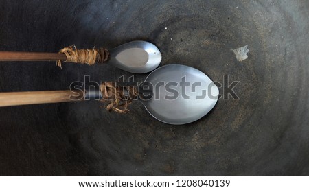 Old stainless steel spoon On a black background
