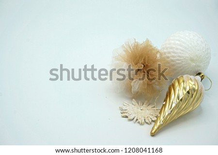  White and gold Christmas ornaments of different textures and materials, including textile, straws, metal and different shapes, isolated on white. Copy space.                              