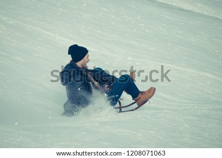Students have fun in the winter. Active weekend on a winter day, Christmas holidays. boy sledding off the mountain