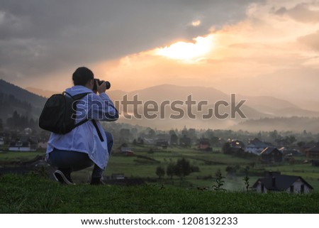 Professional nature photographer taking photos in mountains