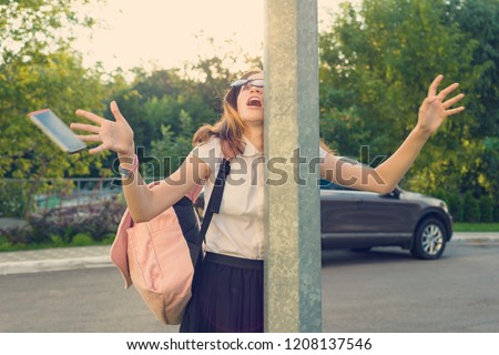 Portrait of young inattentive girl, distracted by mobile phone. Girl crashed into street post, dropped phone. Royalty-Free Stock Photo #1208137546
