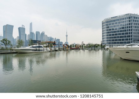 The landmark platform of the modern commercial city and the urban yacht wharf - the prosperous scene with the background of Shanghai Global Financial Center.