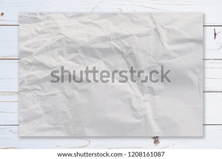 Crumpled paper on wooden paint white background texture with coffee space.