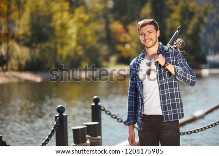 Picture of young fisherman fishing with rods