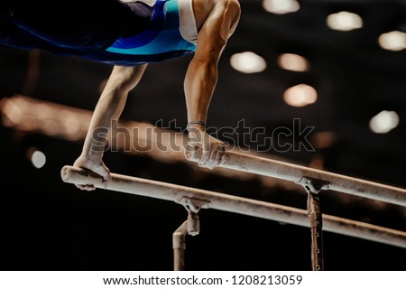 gymnast exercise parallel bars in artistic gymnastics