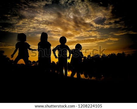 Silhouetted childhood's sunset moment