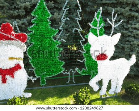 Christmas heroes figures reindeer and snowman composition over green fir background
