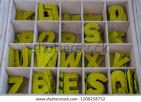 Shiny letters in a wooden box