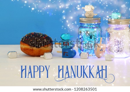 Image of jewish holiday Hanukkah with dreidels colection (spinning top) and doughnut