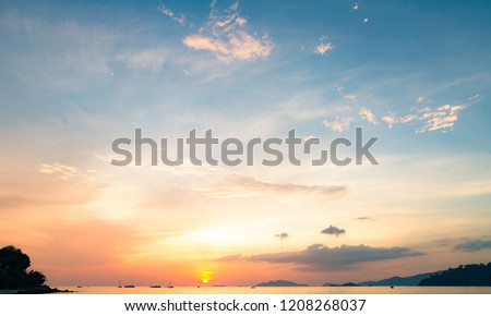 Motivational concept: Sea with yellow and blue sky with ocean sunrise background
