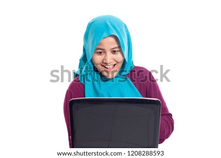 Portrait of muslim businesswoman wearing hijab using laptop with shocked surprised excited facial expression gesture, isolated on white